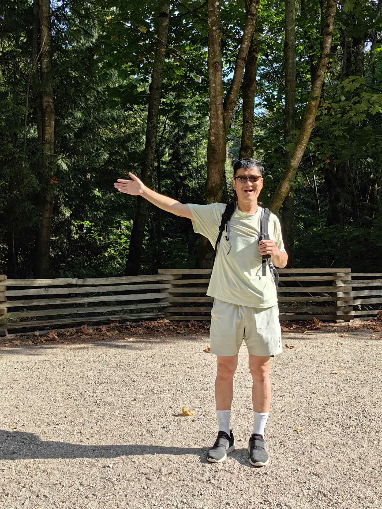 Patrick Ni guiding hikers at a trail fork